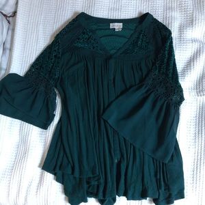 Forest green bell sleeve top from Anthropologie